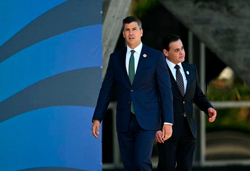 Paraguay’s President Santiago Pena (L) is pictured before the group photo after the first session of the G20 Leaders’ Meeting in Rio de Janeiro, Brazil, on November 18, 2024.