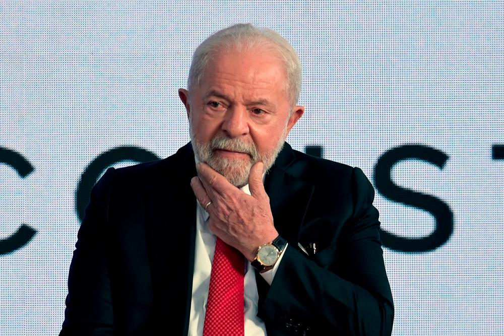 The president of Brazil, Luiz Inacio Lula da Silva, gestures during an event where he signed a bill recognising community health agents and agents fighting endemic diseases as health professionals, with regulated professions, at the Palacio do Planalto, in Brasilia, on January 20, 2023. - AFPPIX