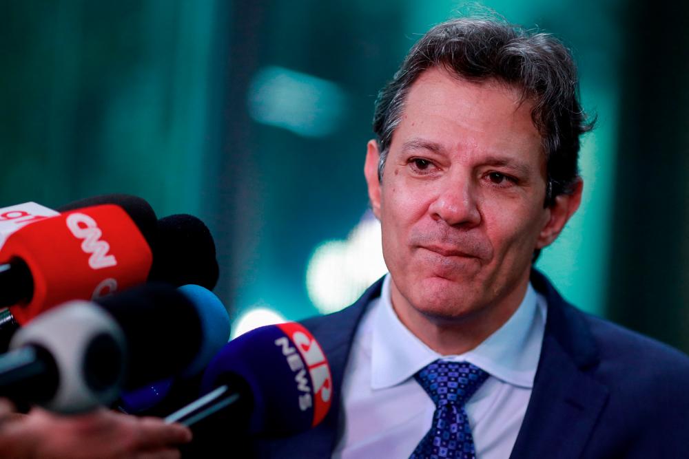Haddad speaking with journalists after a meeting with Brazil central bank president Roberto Campos Neto in Brasilia on Monday, April 3. – Reuterspiec