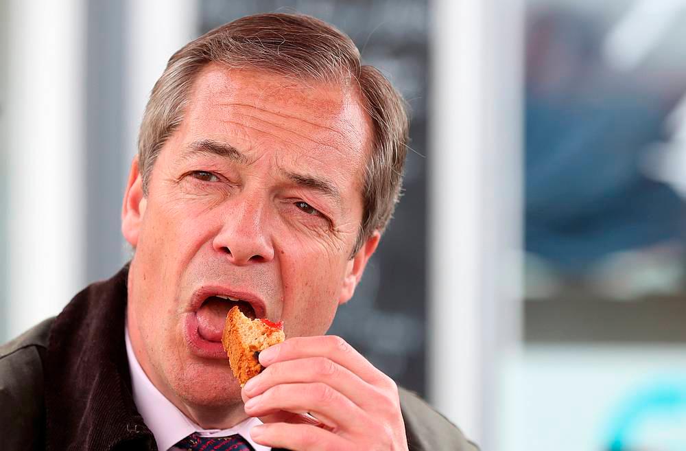 Brexit Party leader Nigel Farage eats a snack during a Brexit Party campaign event in Hartlepool, Britain May 11, 2019. — Reuters