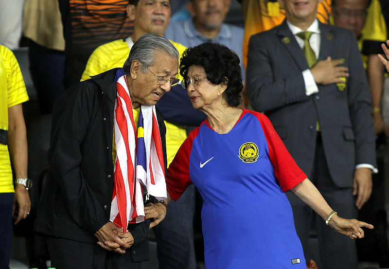 Prime Minister Tun Dr Mahathir Mohamad and wife Tun Dr Siti Hasmah Mohd Ali decked in the national team jerseys during the first leg of the AFF Suzuki Cup final between Malaysia and Vietnam at the Bukit Jalil Stadium, on Dec 11, 2018. — Bernama
