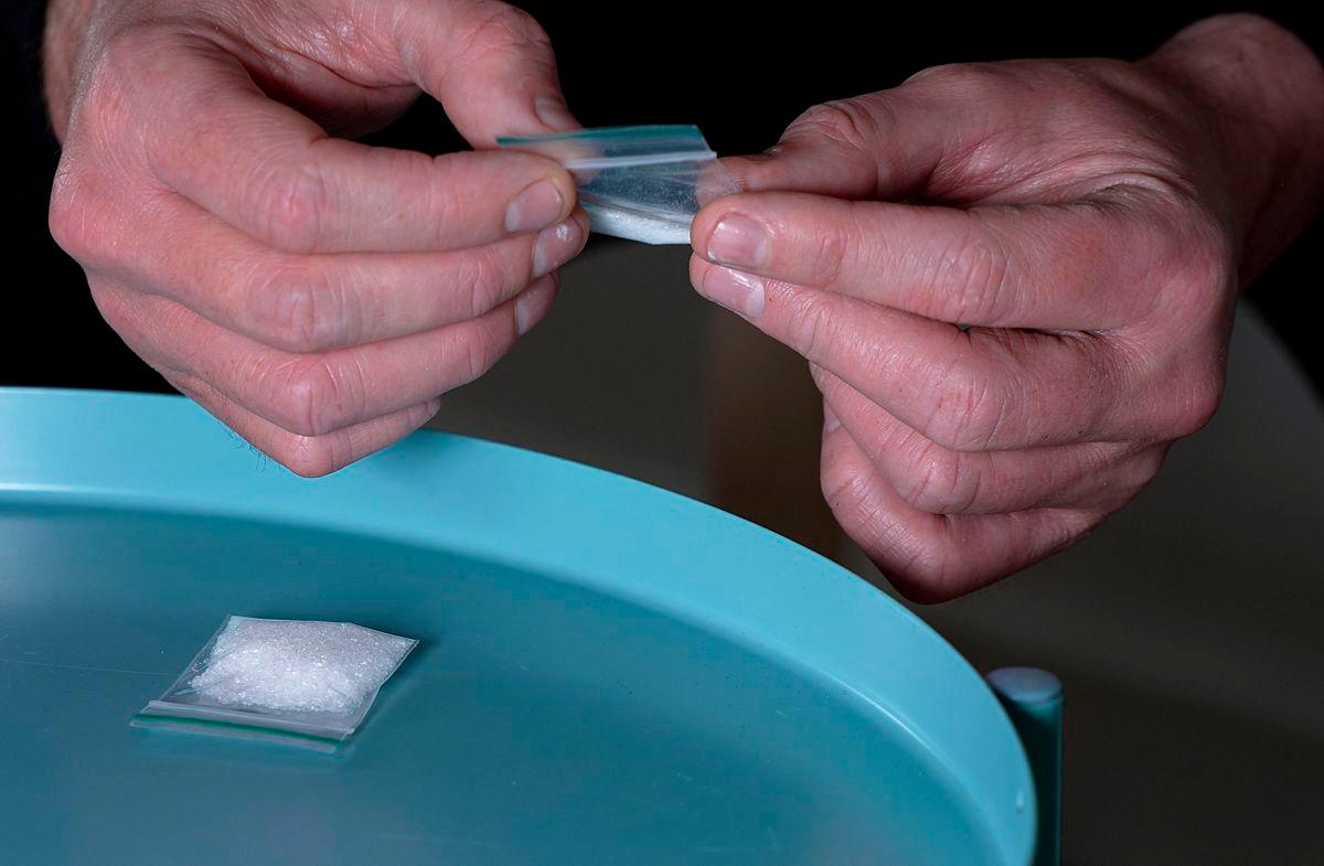 A still image taken from AFPTV shows a dealer holding a bag of ketamine in London on June 19, 2025. AFPPIX