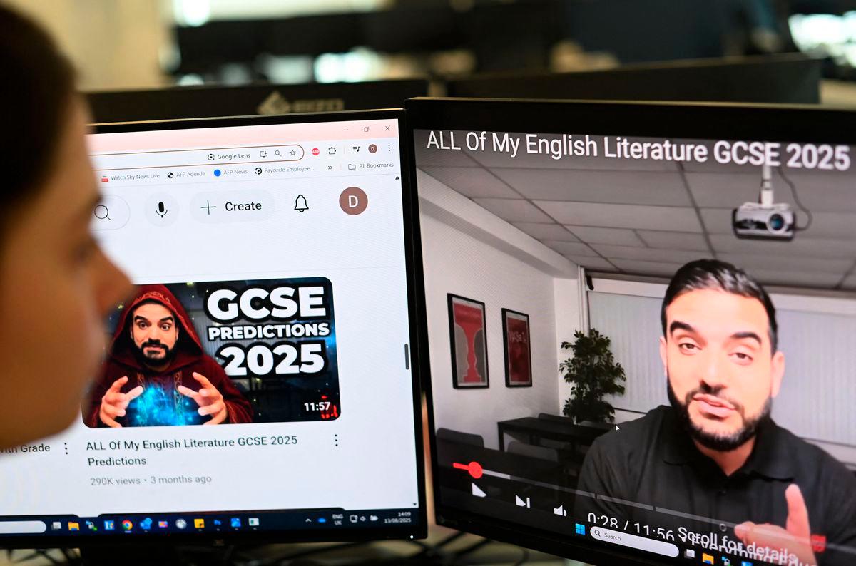A posed photograph taken as an illustration in London on August 13, 2025 shows a journalist looking at a video by former teacher Waqar Malik on his “Mr Everything English” channel. AFPPix