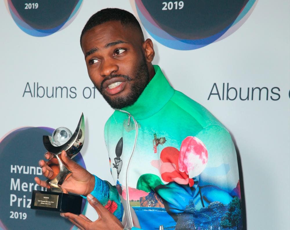 British rapper Dave poses with the Mercury Prize award for his album ‘Psychodrama’ after the awards ceremony in central London on September 19, 2019. Angst-filled rapper Dave scooped up Britain’s coveted Mercury Prize on Thursday in a political-charged London finale that included a mouthy expletive shouted from stage at Prime Minister Boris Johnson. - Restricted to editorial use, no marketing no advertising campaigns - to illustrate the event as described in the caption.
