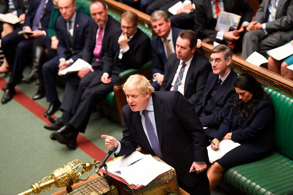 A handout picture released by the UK Parliament shows Britain's Prime Minister Boris Johnson speaking during Prime Minister's Questions (PMQs) in the House of Commons in London on February 26, 2020. - AFP