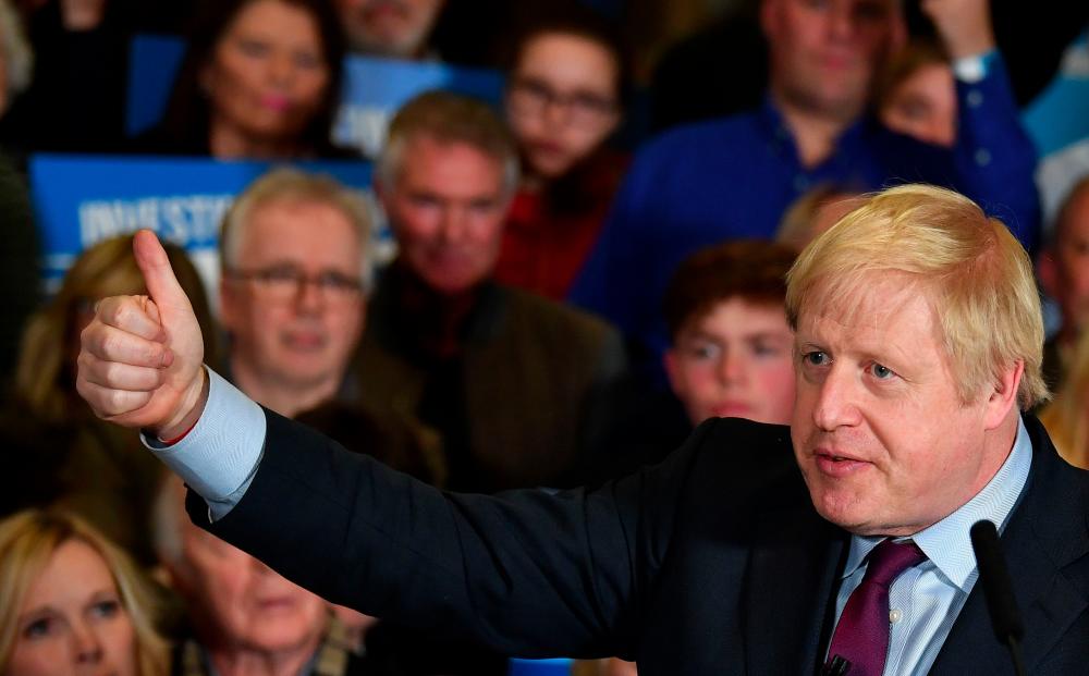 Britain's Prime Minister and Conservative party leader Boris Johnson speaks during a general election campaign rally in Quedgeley, near Gloucester, western England, on Dec 9. — AFP