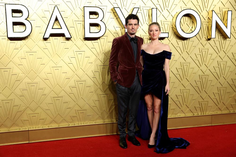 French-US film director Damien Chazelle (L) and Olivia Hamilton pose on the red carpet upon arrival for the UK Premiere of ‘Babylon’, at BFI IMAX in London, on January 12, 2023/AFPPix