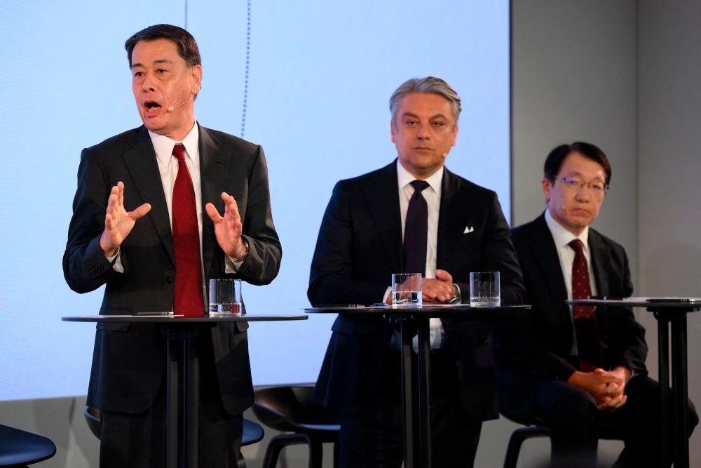 From left: Uchida, de Meo and Mitsubishi Motors CEO Takao Kato at a press conference in London on Mpnday. – AFPpic