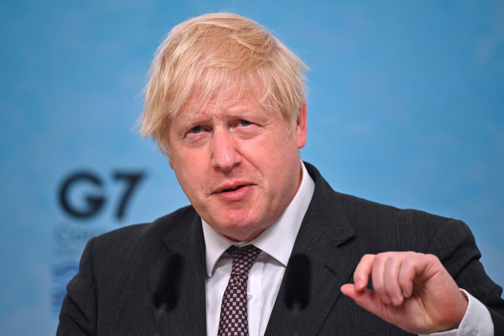 Britain's Prime Minister Boris Johnson takes part in a press conference on the final day of the G7 summit in Carbis Bay, Cornwall on June 13, 2021. – AFP