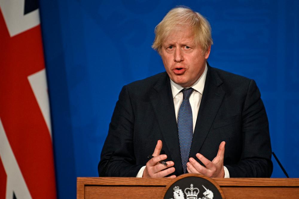 Britain's Prime Minister Boris Johnson gives an update on relaxing restrictions imposed on the country during the coronavirus covid-19 pandemic at a virtual press conference inside the Downing Street Briefing Room in central London on July 12, 2021. – AFP