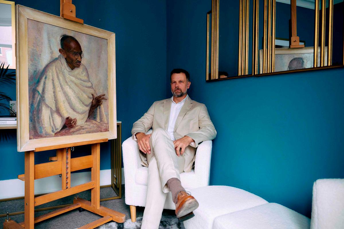 Caspar Leighton, great-nephew of British-American artist Clare Leighton, poses with a painting by his great-aunt of Indian independence leader Mahatma Gandhi at Bonhams auction house in London on June 9, 2025.