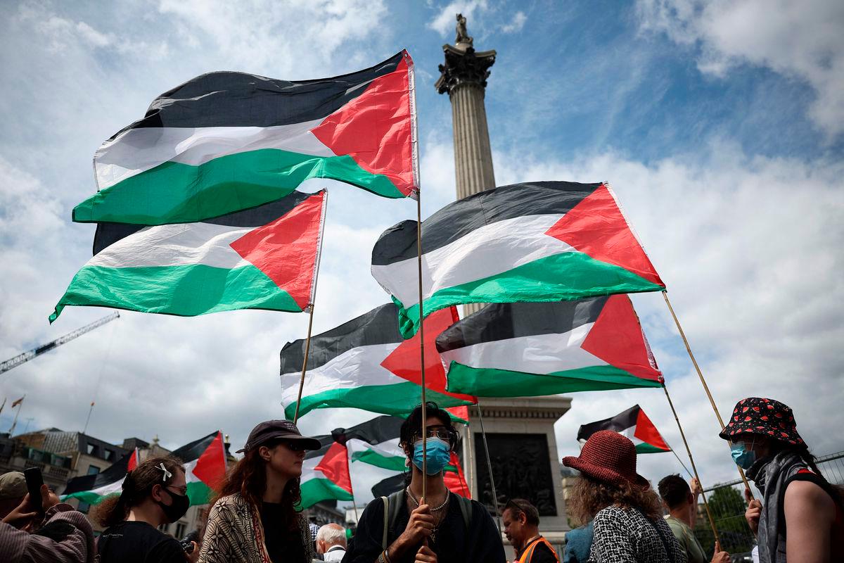 Flags of Palestine fly during a protest in support of pro-Palestinian group Palestine Action, in Trafalgar Square, central London, on June 23, 2025. (Photo by HENRY NICHOLLS / AFP)
