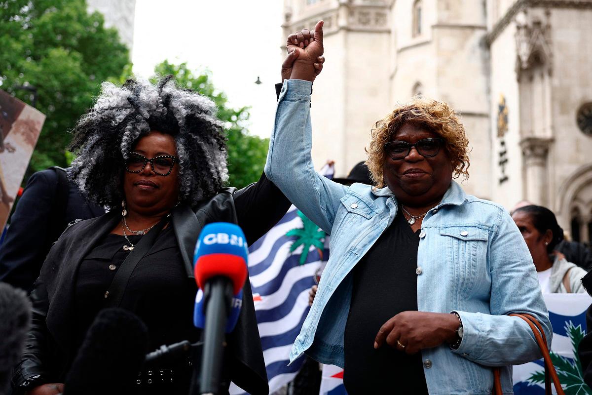 Members of the Chagossian community, Bertrice Pompe (L) and Bernadette Dugasse (R) reacts after making a statement outside the High Court in London on on May 22, 2025, after a hearing into the fate of the Chagos Islands goes against them. A judge at London's High Court on Thursday lifted a temporary block on the UK government concluding its deal to return the remote Chagos Islands to Mauritius. - HENRY NICHOLLS / AFP