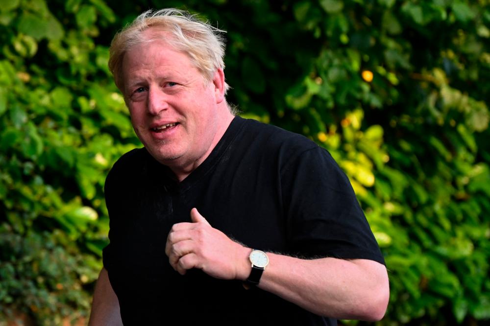 Former British Prime Minister Boris Johnson leaves his house for a run in Brightwell-cum-Stowell, west of London on June 14 2023/AFPPix