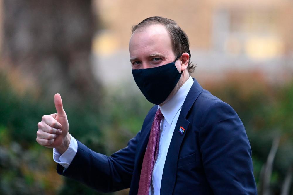 Britain’s Health Secretary Matt Hancock gives a thumbs up as he walks in Downing street in London on March 19, 2021. - AFP