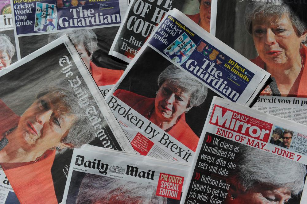An arrangement of UK daily newspapers photographed as an illustration in London on May 25, 2019 shows front page headlines reporting on the resignation speech of Britain's Prime Minister Theresa May. - AFP