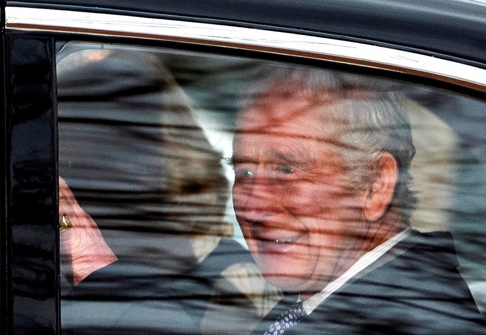 Britain’s King Charles III waves as he travels with his wife Britain’s Queen Camilla, from Clarence House to Buckingham Palace, in London on February 6, 2024. Britain’s King Charles III was on Tuesday seen in public for the first time since his cancer diagnosis was made public a day before/AFPPix