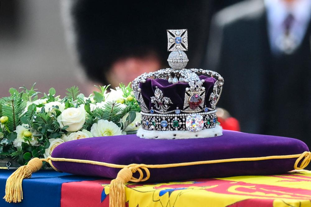The coffin of Queen Elizabeth II, adorned with a Royal Standard and the Imperial State Crown is pulled by a Gun Carriage of The King’s Troop Royal Horse Artillery, during a procession from Buckingham Palace to the Palace of Westminster, in London/AFPPix