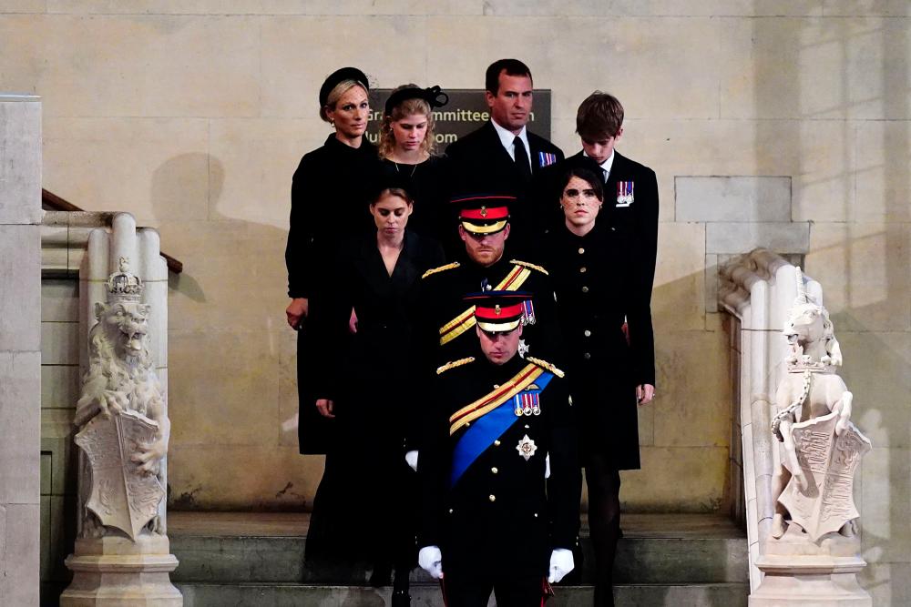 Grandchildren of Queen Elizabeth II, bottom to top, Britain’s Prince William , Prince of Wales leads his brother Britain’s Prince Harry, Duke of Sussex, followed by their cousins Britain’s Princess Beatrice of York and Britain’s Princess Eugenie of York, Britain’s Lady Louise Windsor and Britain’s James, Viscount Severn, and Zara Tindall and Peter Phillips arrive to hold a vigil around her coffin in Westminster Hall, at the Palace of Westminster in London/AFPPix