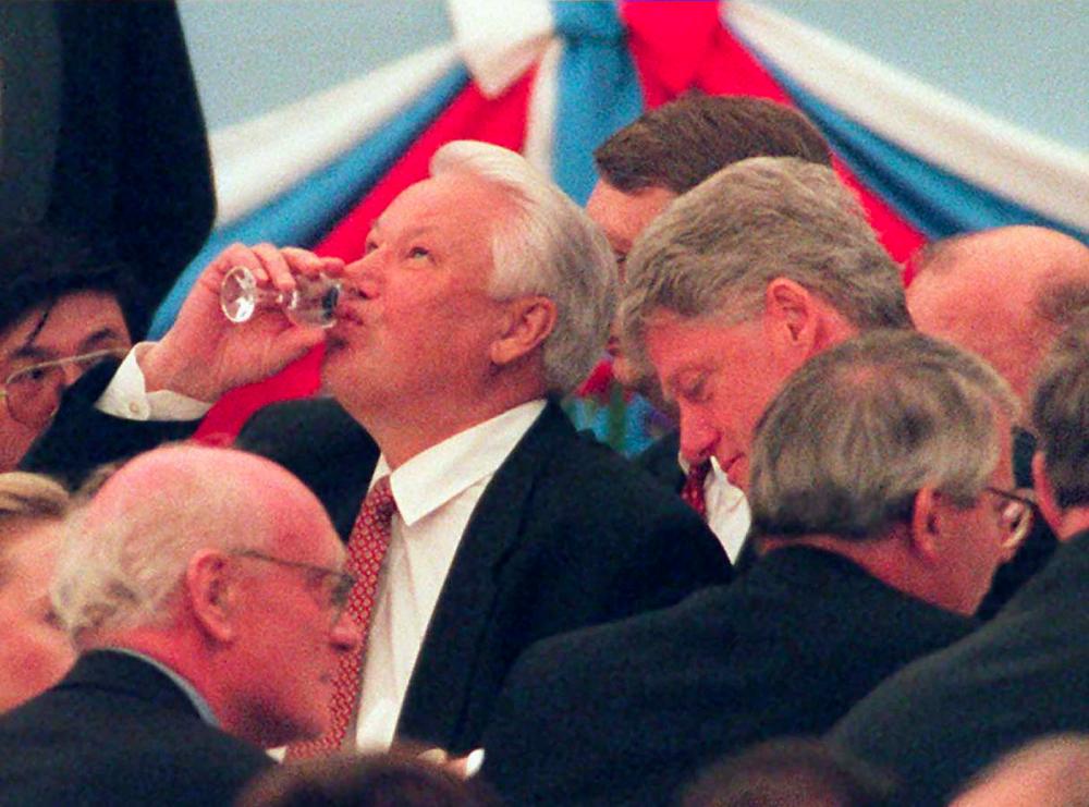 In this file photo taken on May 9, 1995 shows Russian President Boris Yeltsin (C) finishing his glass of vodka at the reception of heads of state in the Kremlin. — AFP