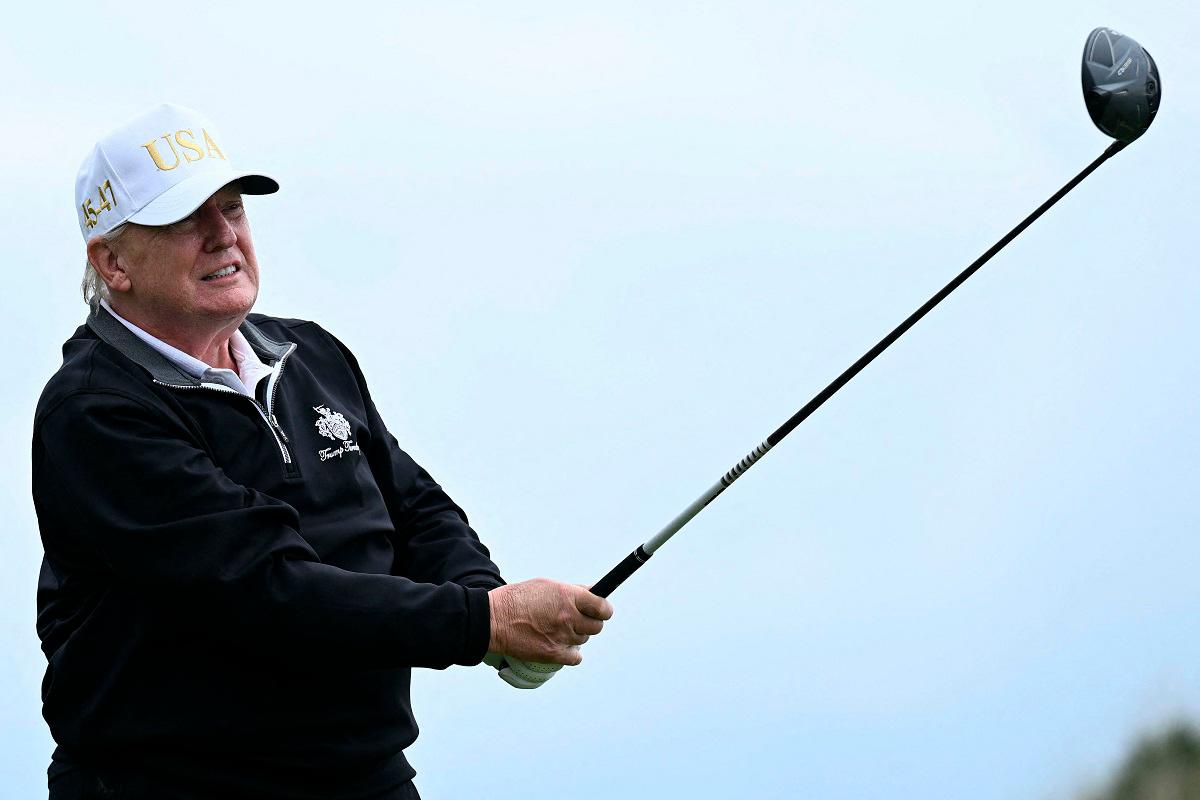 US President Donald Trump watches his drive after playing from the first tee to officially open the Trump International Golf Links course in Balmedie, Aberdeenshire, north east Scotland on July 29, 2025. - SMIALOWSKI / AFP