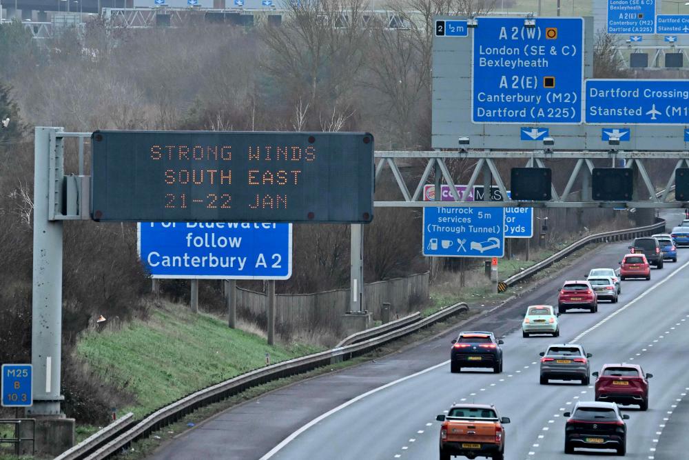 Warnings for strong winds are displayed to traffic using the M25 motorway, near Swanley, south of London on January 21, 2024. Amber warnings for wind were in place in the UK on Sunday, as Storm Isha approached the country. - AFPPIX
