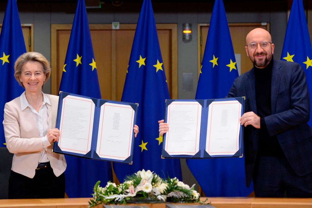 Von der Leyen (left) and Michel showing the signed Brexit trade agreement due to come into force on Jan 1, 2021, in Brussels on Wednesday. – AFPPIX