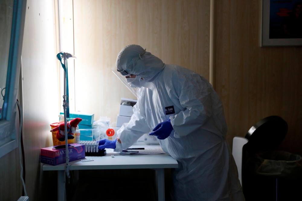 A healthcare worker works at a Covid-19 testing site as the spread of the coronavirus disease (Covid-19) continues in Budapest, Hungary, October 27, 2020. — Reuters