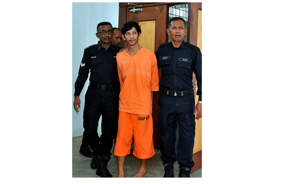 Muhammad Khairil Nawi is led out of the magistrate’s court in Besut, on May 16, 2019. — Bernama