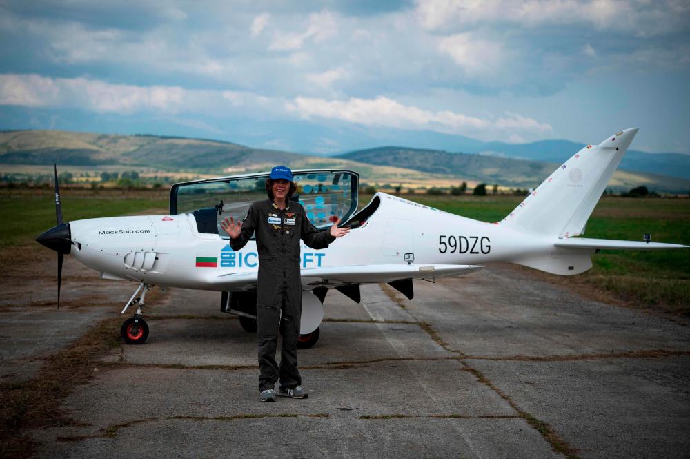 Mack Rutherford, 17, the youngest person to fly solo around the world, waves to journalists and relatives, after landing at Sofia West airport near Radomir on August 24, 2022. AFPPIX