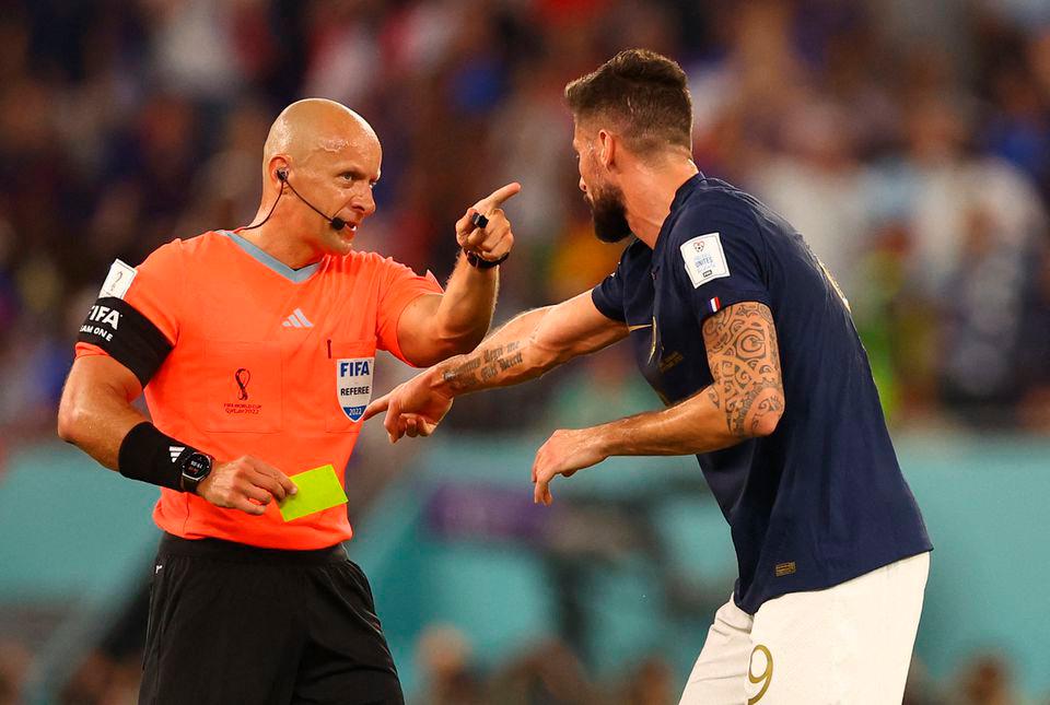 FIFA World Cup Qatar 2022 - Group D - France v Denmark - Stadium 974, Doha, Qatar - November 26, 2022 France’s Olivier Giroud reacts towards referee Szymon Marciniak before he shows Denmark’s Andreas Christensen a yellow card for a foul on Kylian Mbappe. REUTERSPIX