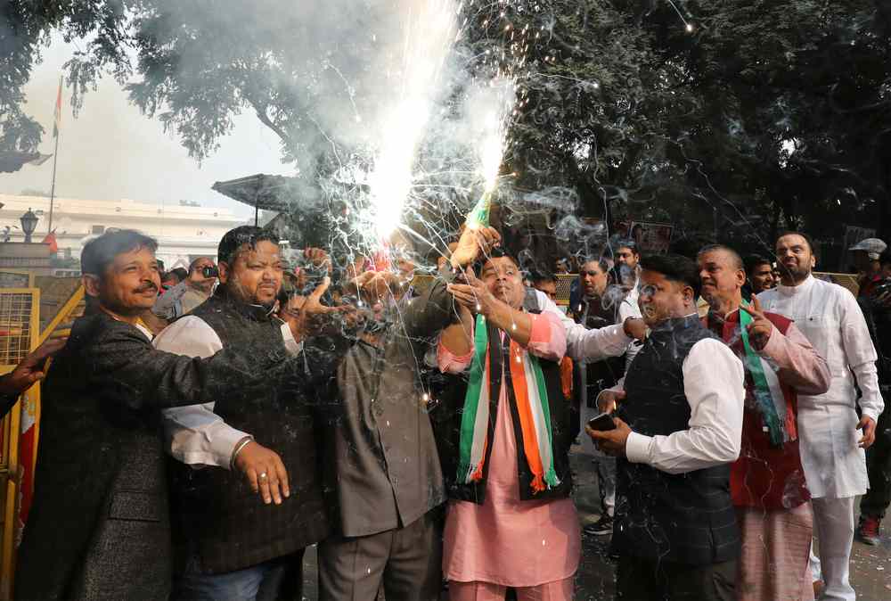 Supporters of India’s main opposition Congress party celebrate after initial poll results at the party headquarters in New Delhi Dec 11, 2018. — Reuters