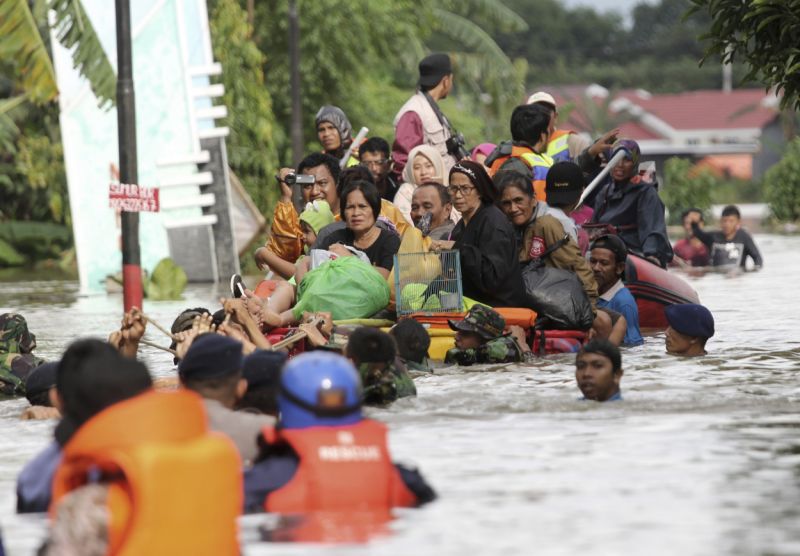 Residents ride a makeshift raft as they evacuate their flooded homes in Makassar, South Sulawesi, Indonesia, Wednesday, Jan. 23, 2019. — Reuters