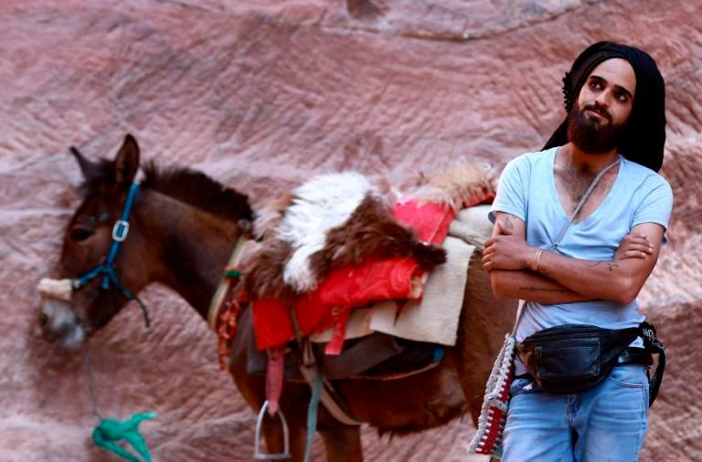 A Jordanian donkey owner waits for customers at Petra, where many workers have struggled to earn an income after tourist numbers dried up amid the coronavirus pandemic. — AFP