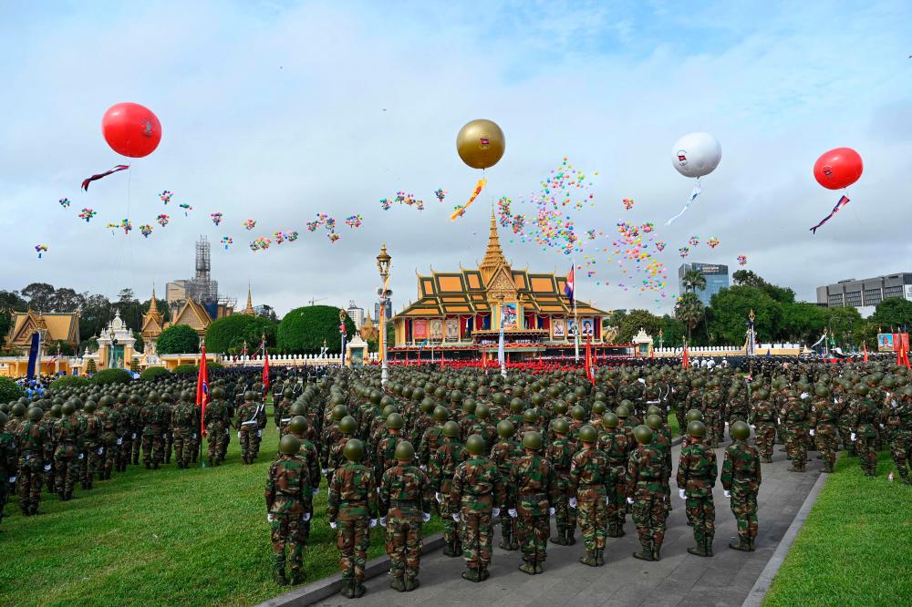 Balloons are released as soldiers stand in formation during Independence Day celebrations in front of the Royal Palace in Phnom Penh on November 9, 2023, as Cambodia celebrates the 70th anniversary of its independence from France/AFPPix