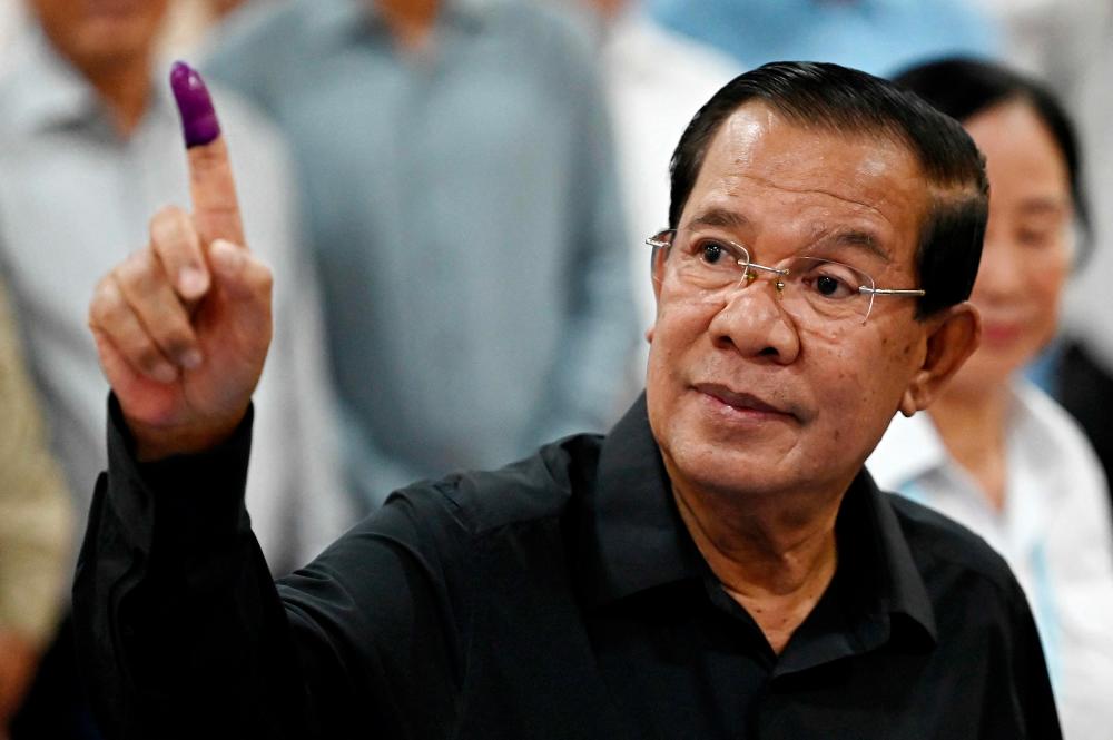 Member of parliament and Cambodia's former prime minister Hun Sen shows his inked finger after voting at a polling station during the Senate election in Takhmao city, Kandal province on February 25, 2024. - AFPPIX
