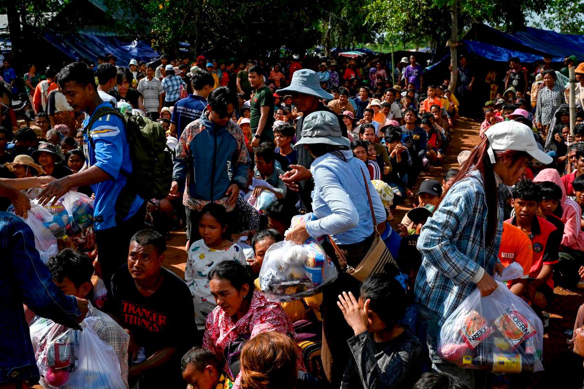 People who fled their homes near the border between Cambodia and Thailand gather at a food distribution site on the grounds of a pagoda in Oddar Meanchey province on July 28, 2025. - AFPPix