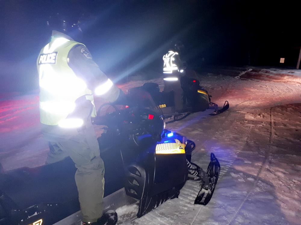 Image courtesy Sûreté du Québec obtained Jan 22, shows police on snowmoblies during search and rescue operations near Beemer Island, Quebec, Canada, after a Canadian guide died and five French tourists went missing when their snowmobiles plunged through ice into the freezing water, according to police. — AFP