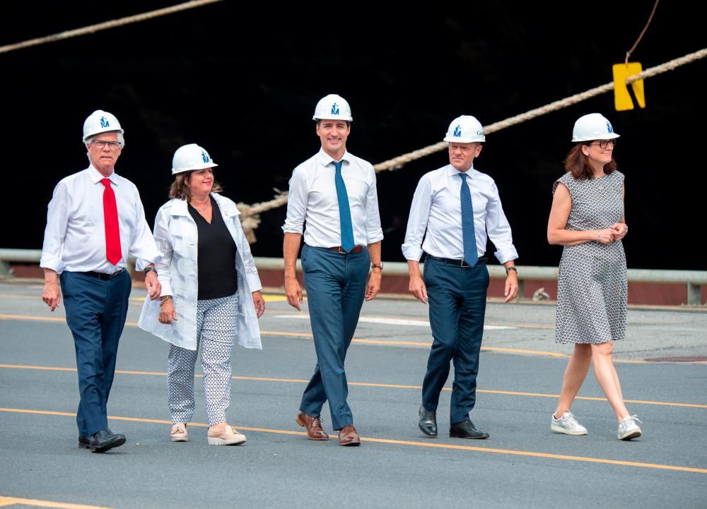 Canadian Prime Minister Justin Trudeau (C) visit the Port of Montreal along with the President of the European Council Donald Tusk (2nd R), European Commissioner for Trade Cecilia Malmstrom (2nd L), Minister of International Trade Diversification Jim Carr (L) and Montreal Port Authority President and CEO Sylvie Vachon, in Montreal, Canada, on July 17, 2019. — AFP