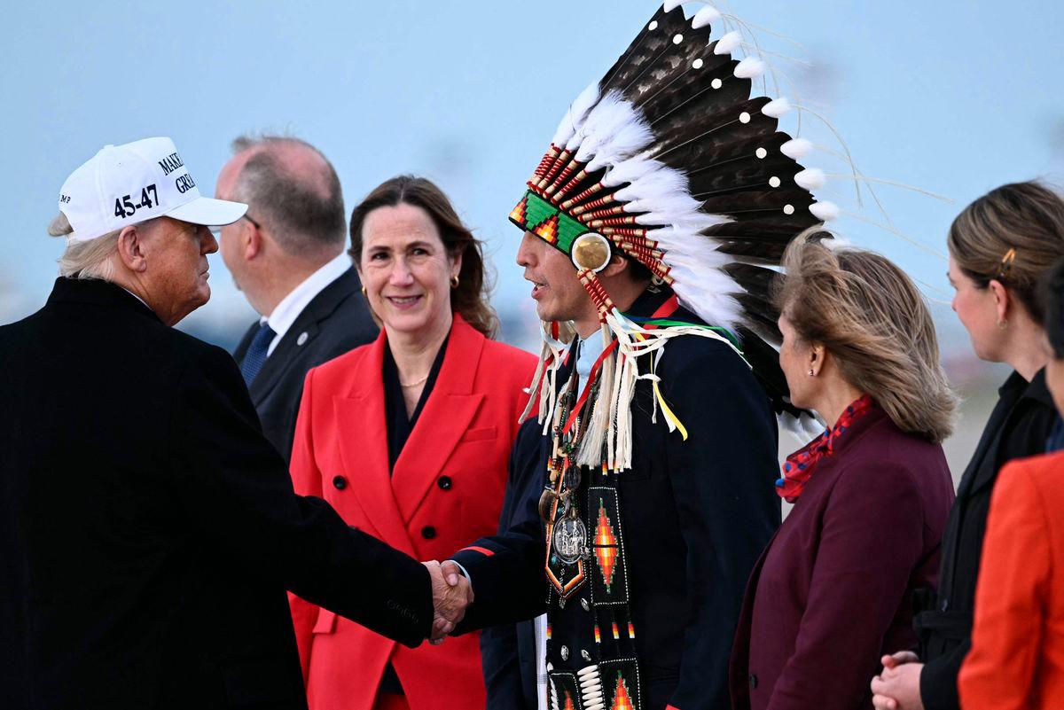 US President Donald Trump (L) is greeted by Steven Crowchild of the Tsuut’ina First Nation (3R) upon arrival at Calgary International Airport, before the start of the G7 summit, in Calgary, Alberta, Canada, June 15, 2025. AFPpix
