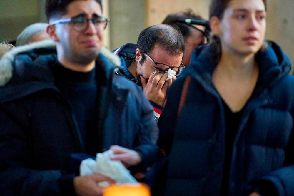 A man weeps during a memorial service at Western University in London, Ontario on Jan 8, for the four graduate students who were killed in a plane crash in Iran. — AFP