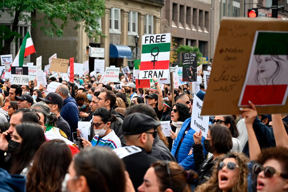 People demonstrate during a protest for Mahsa Amini who died in custody of Iran’s morality police, in Montreal, Quebec, Canada/AFPPix