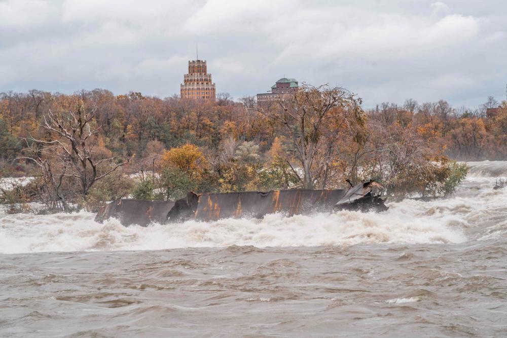 This handout picture released by Niagara Parks on Nov 1, 2019 shows the carcass of the Iron Scow lodged in the rapids above the Canadian Horseshoe Falls in Ontario, Canada. — AFP