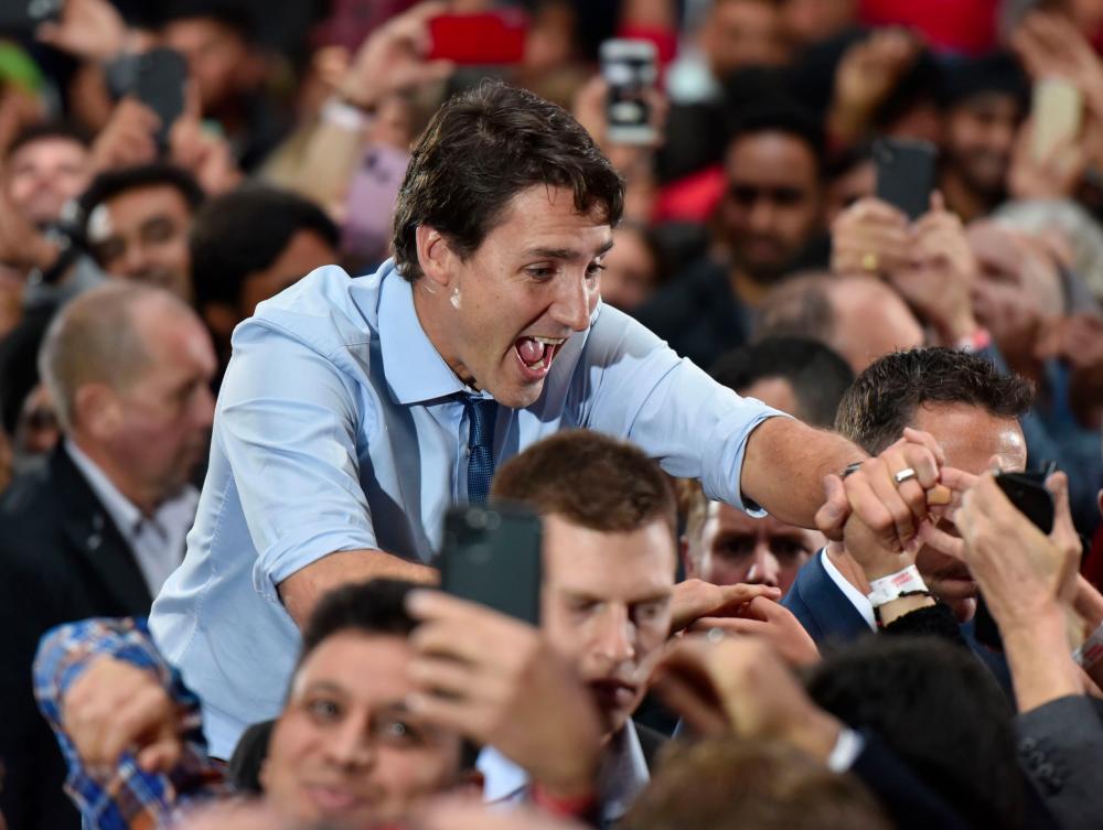 Leader of the Liberal Party of Canada, Prime Minister, Justin Trudeau, greets his supporters during a Team Trudeau 2019 Rally at the Woodward’s Atrium in Vancouver B.C. on Oct 20, 2019. — AFP
