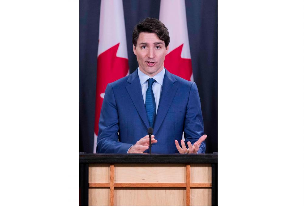 In this file photo taken on Mar 7, Canadian Prime Minister Justin Trudeau speaks to the media at the national press gallery in Ottawa, Ontario. — AFP