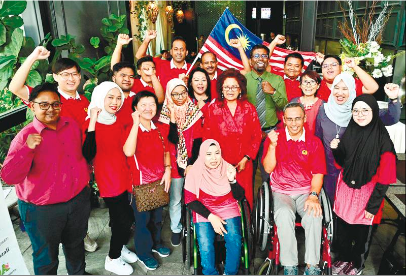 Khatijah (centre) with the 16 differently-abled Malaysians who will be competing in France starting today.