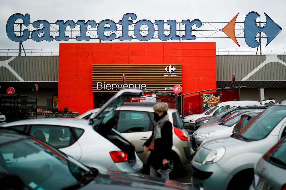 A customer is seen in front of a Carrefour hypermarket store in Carquefou near Nantes, France. – REUTERSPIX