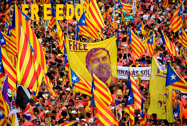 Demonstrators hold a banner demanding freedom for Catalan jailed leader Oriol Junqueras as they gather to take part in a pro-independence demonstration in Barcelona. — AFP