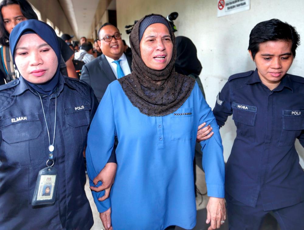 Datuk Zahrah Abd Wahab Fenner (C) is led to the Kuala Lumpur sessions court, on Oct 2, 2019. — BBX-Images