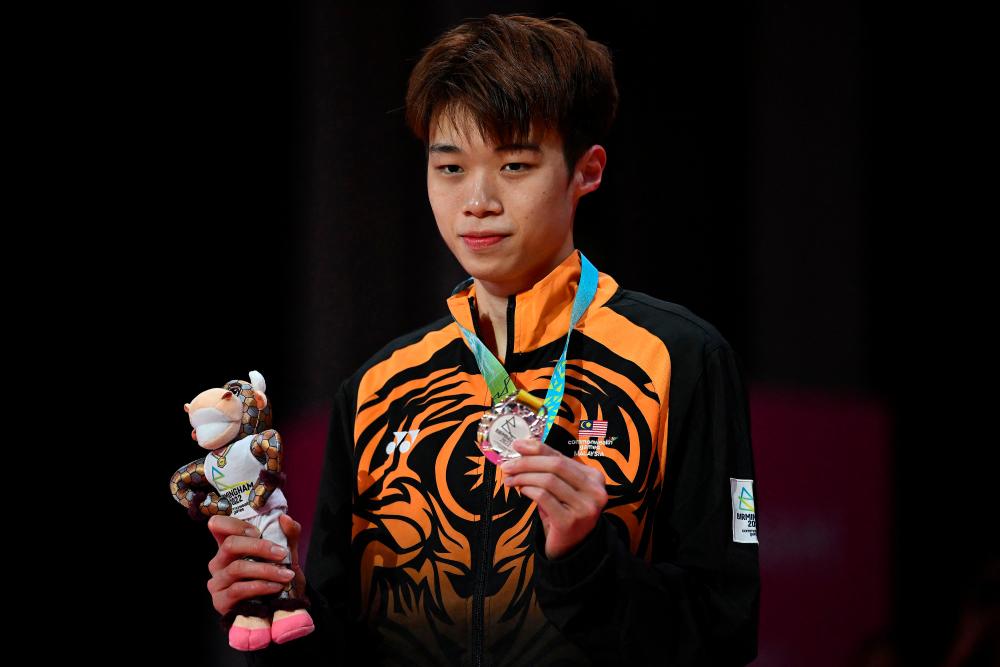 Silver medallist Malaysia’s Tze Yong Ng poses during the medal presentation ceremony for the men’s singles gold medal badminton match on day eleven of the Commonwealth Games at the NEC arena in Birmingham, central England, on August 8, 2022. AFPPIX